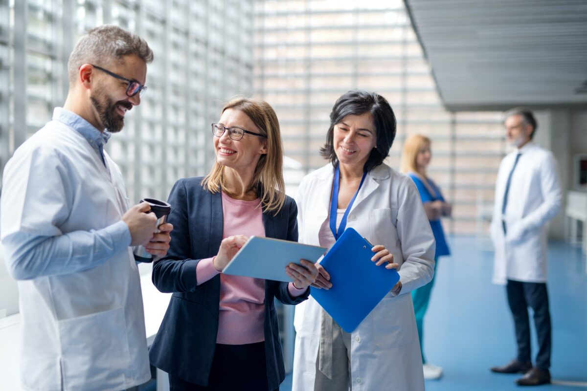 Group of doctors talking to pharmaceutical sales representative