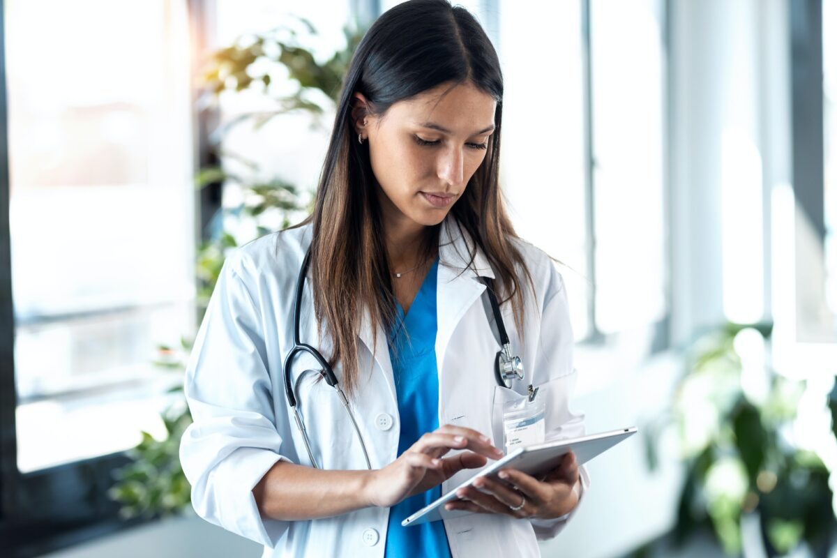 young female doctor reviewing the patient's medical history on her digital tablet